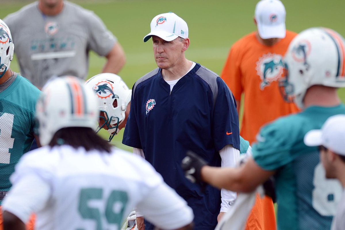May 22, 2012; Davie, FL, USA; Miami Dolphins heath coach Joe Philbin (center) talks with his players during organized team activities at the Dolphins training facility. Mandatory Credit: Steve Mitchell-US PRESSWIRE