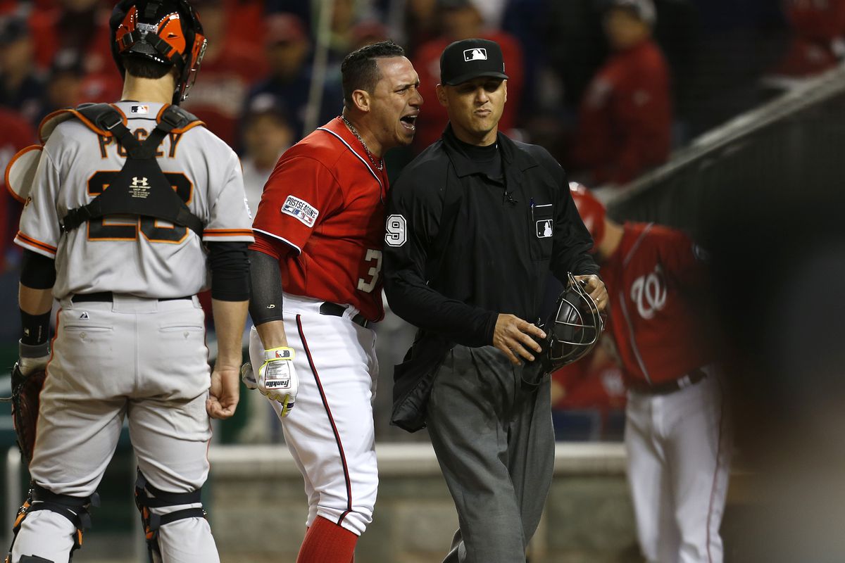 Washington Nationals’ Asdrubal Cabrera (3) yells at home plate umpire Vic Carapazza (19) after he called out on strikes against the San Francisco Giants in the 10th inning at Nationals Park for Game 2 of their NLDS series in Washington D.C., on Saturday,
