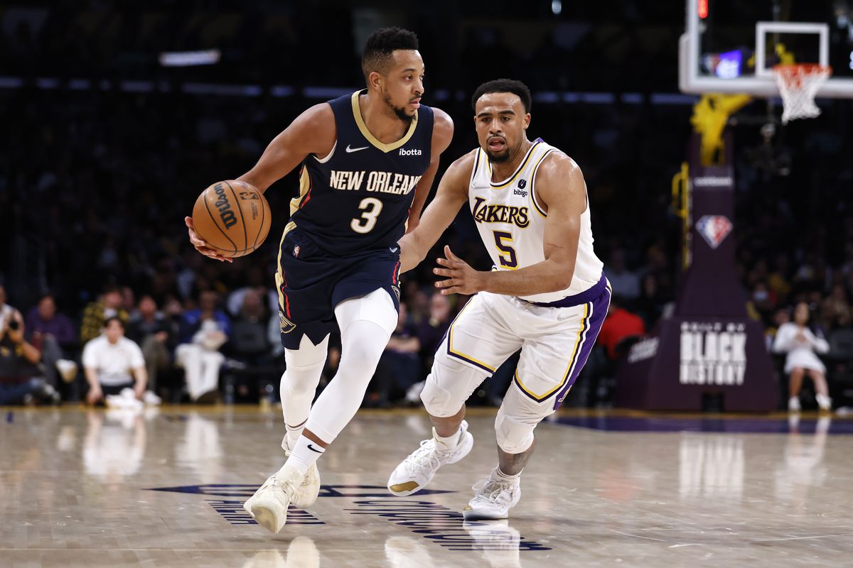 CJ McCollum #3 of the New Orleans Pelicans dribbles against Talen Horton-Tucker #5 of the Los Angeles Lakers during the second half at Crypto.com Arena on February 27, 2022 in Los Angeles, California.