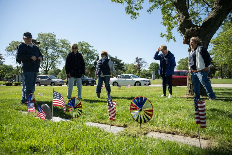 Jerry Frost (from left), Daphne Frederick, Deb Frost Baker, Kathleen Frost Roth and Sandy Frost Somrek, all relatives of Col. Helen L. McCormick, chat near after tending her headstone Saturday at St. Mary Catholic Cemetery and Mausoleums in Evergreen Park.