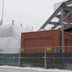 View the of the additional grandstand seating section extending over the utility building, in the left field corner