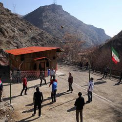 In this Monday, Feb. 2, 2015 photo, drug addicts play volleyball at a treatment camp in Verdij some 15 miles (25 kilometers) northwest of the capital Tehran, Iran. Anti-narcotics and medical officials say more than 2.2 million of Iran's 80 million citizens already are addicted to illegal drugs, including 1.3 million on registered treatment programs. 