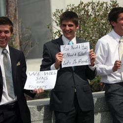 Andrew Dixon, Bradley Laughlin and Matthew Torone look for tickets between sessions of the 183rd Annual General Conference of The Church of Jesus Christ of Latter-day Saints outside the Conference Center in Salt Lake City on Sunday, April 7, 2013.