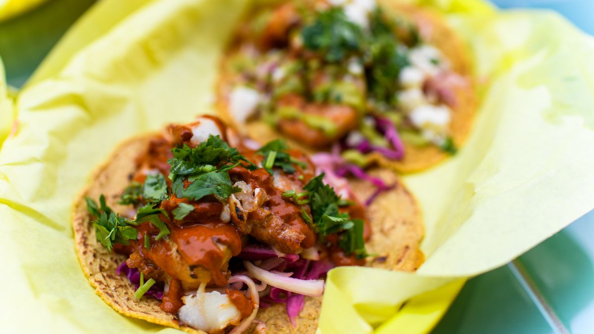 A chicken and a shrimp taco at Papi Chulo’s, which arrive on handmade yellow corn tortillas in a basket lined with yellow paper