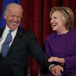 Vice President Joe Biden, left, laughs with former Secretary of State Hillary Clinton during a ceremony to unveil a portrait of Senate Minority Leader Harry Reid, D-Nev., on Capitol Hill, Thursday, Dec. 8, 2016, in Washington. 