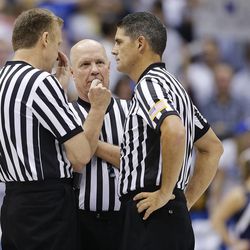 Referees confer at mid-court as BYU and Iowa State play Wednesday, Nov. 20, 2013 in the Marriott Center in Provo. Iowa State won 90-88.
