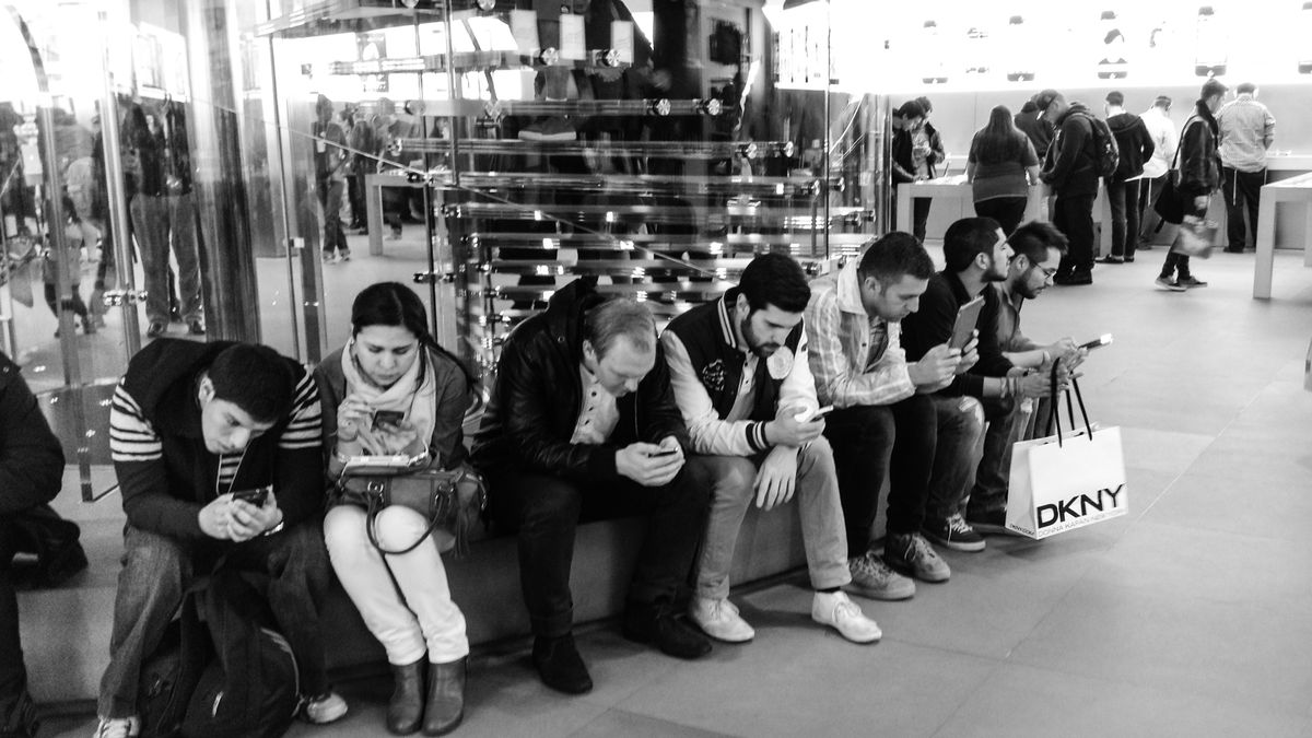 People look at their smartphones and tablets at the Apple Store on Fifth Avenue in New York City in September 2013.