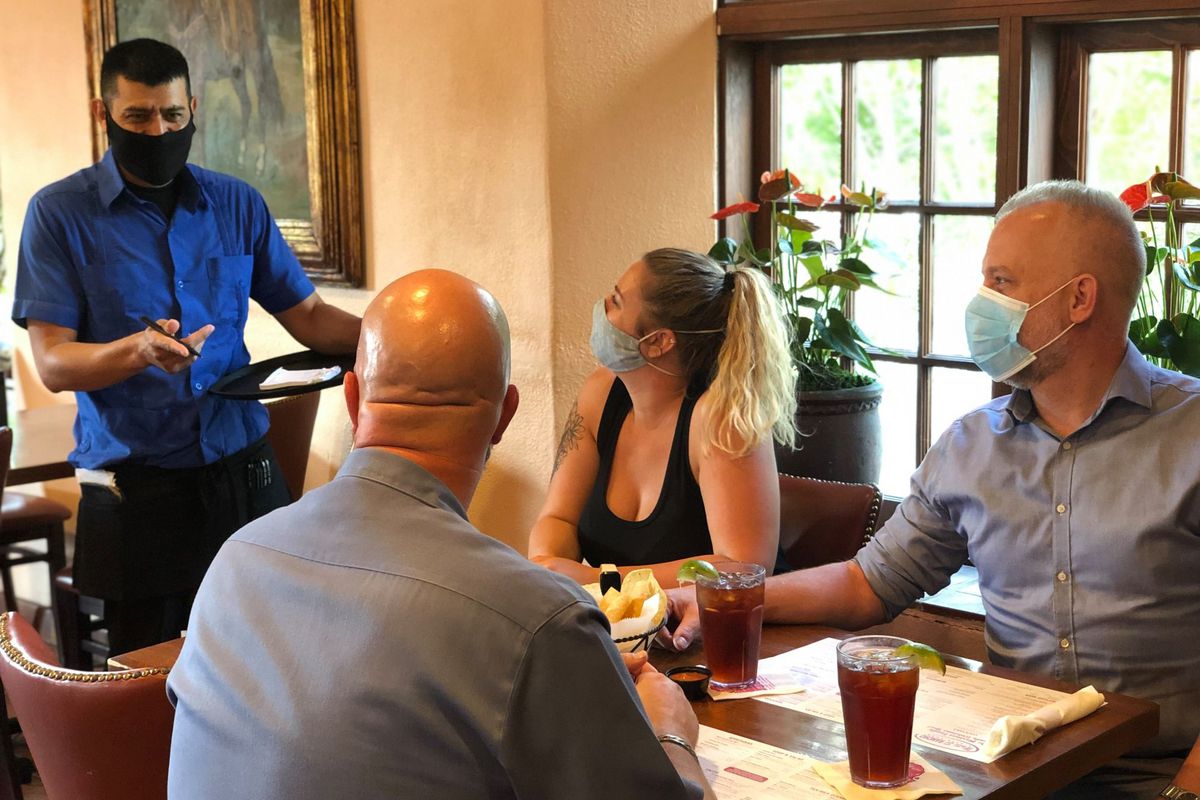 A server attending to a group dining at Matt’s El Rancho