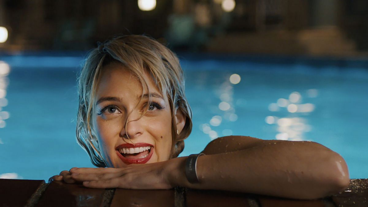 Riley Keough emerging from a pool in Under the Silver Lake.