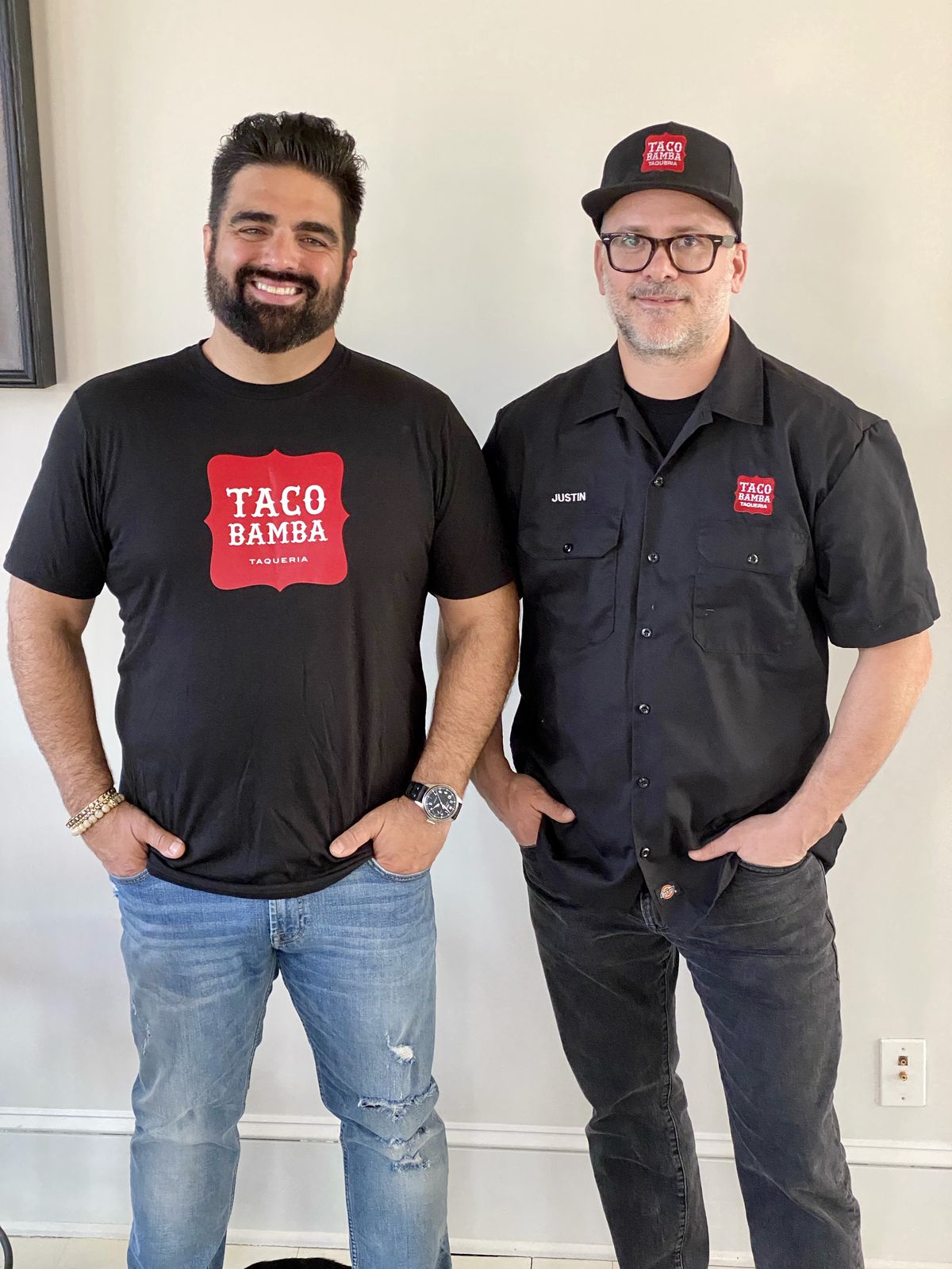 Two men standing in black shirts