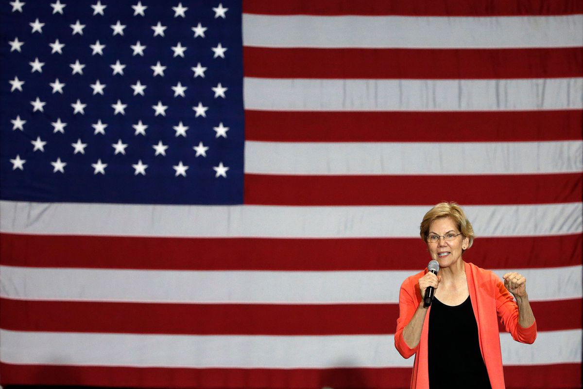 Elizabeth Warren speaking in front of an American flag.