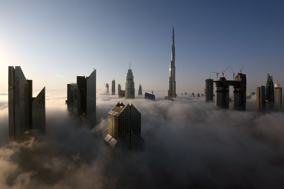 Dubai skyline with buildings poking up out of the fog