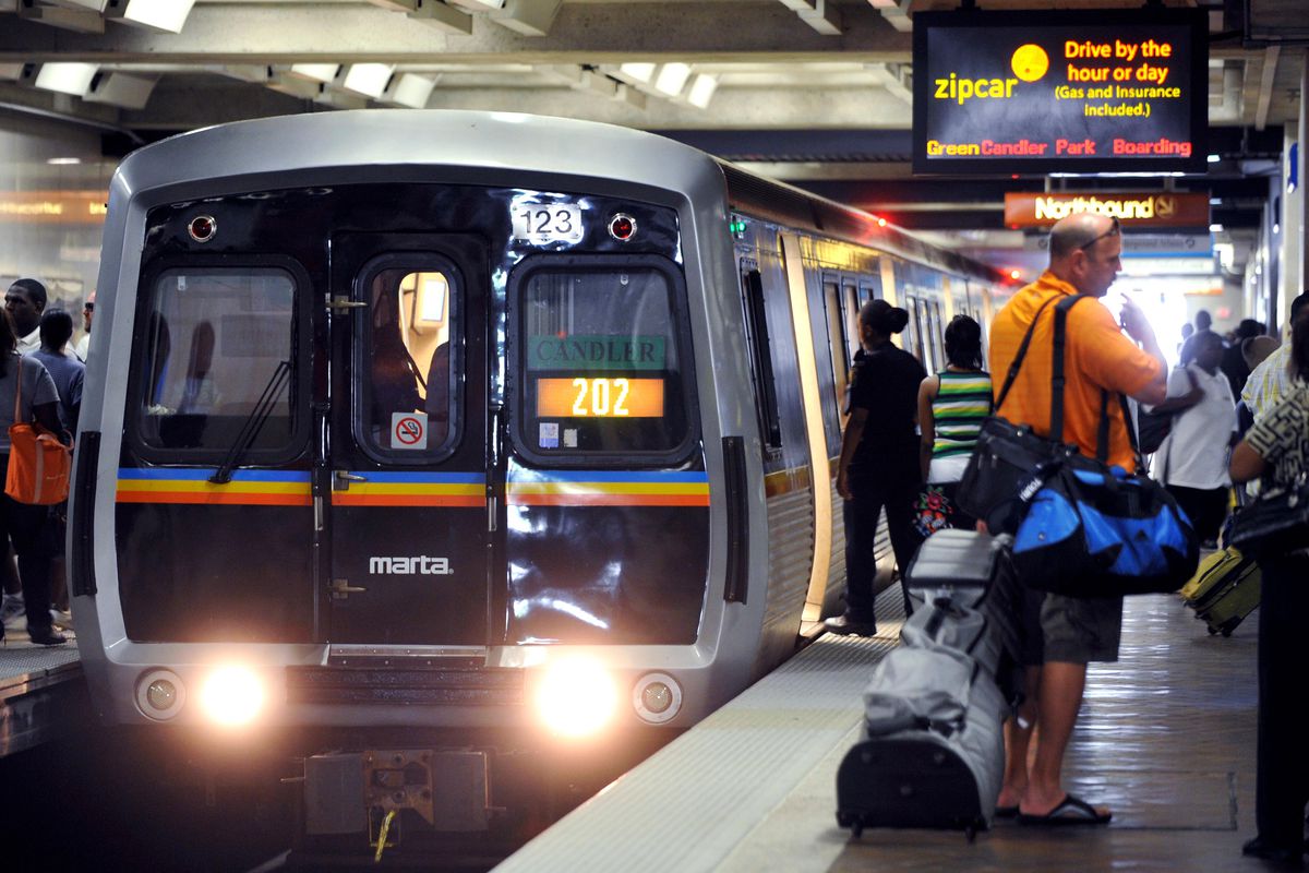 A MARTA train arriving at a crowded platform at Five Points Station.