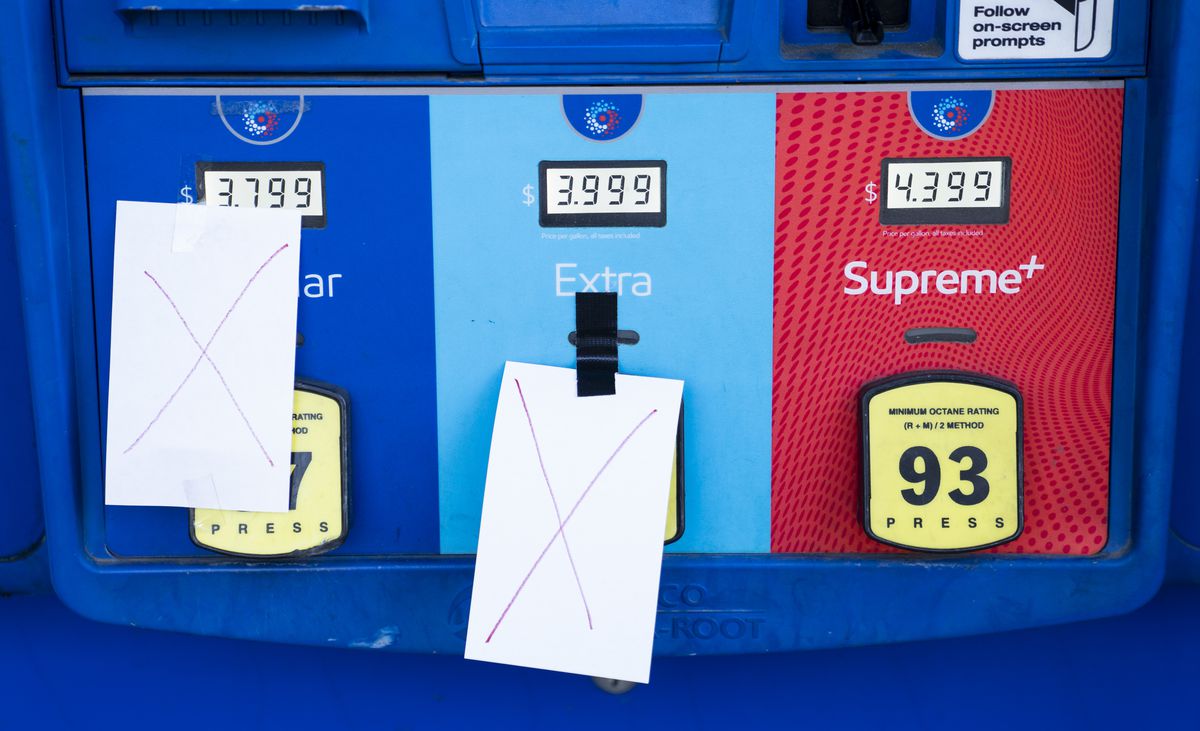 A gas pump with two paper X’s taped to the front, indicating that they are out of gas.