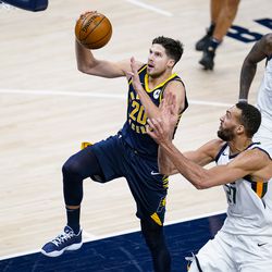 Indiana Pacers forward Doug McDermott (20) shoots in front of Utah Jazz center Rudy Gobert (27) during the second half of an NBA basketball game in Indianapolis, Sunday, Feb. 7, 2021. 