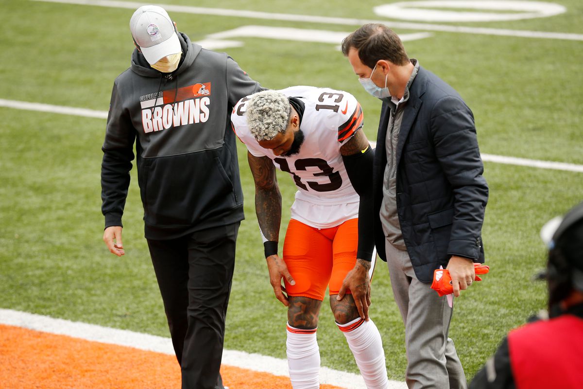 Cleveland Browns wide receiver Odell Beckham Jr. (13) is walked to the locker room after being injured on a play in the first quarter of the NFL Week 7 game between the Cincinnati Bengals and the Cleveland Browns at Paul Brown Stadium in downtown Cincinnati on Sunday, Oct. 25, 2020.