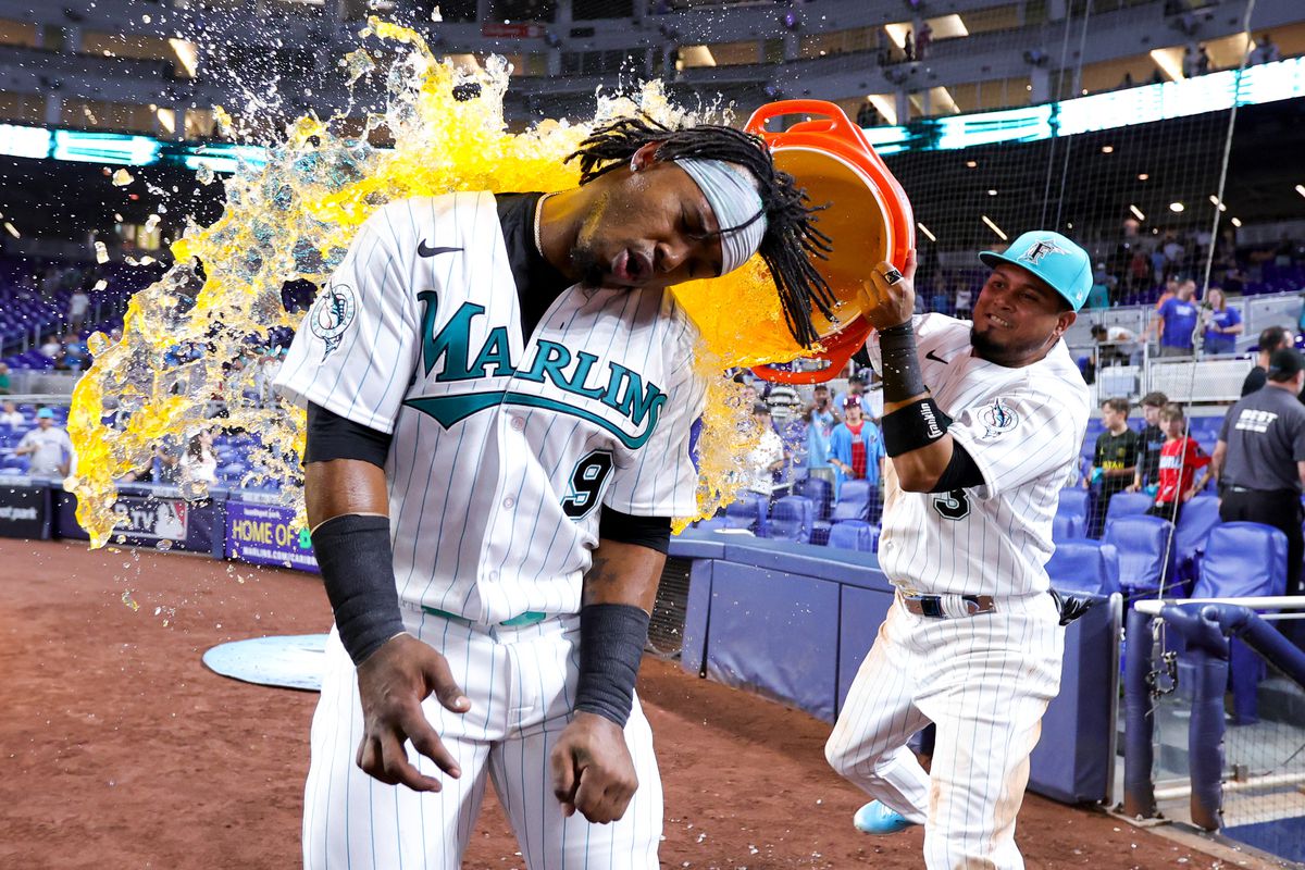 Luis Arraez of the Miami Marlins gives teammate Jean Segura a Gatorade bath after defeating the Chicago Cubs at loanDepot park on April 28, 2023 in Miami, Florida.