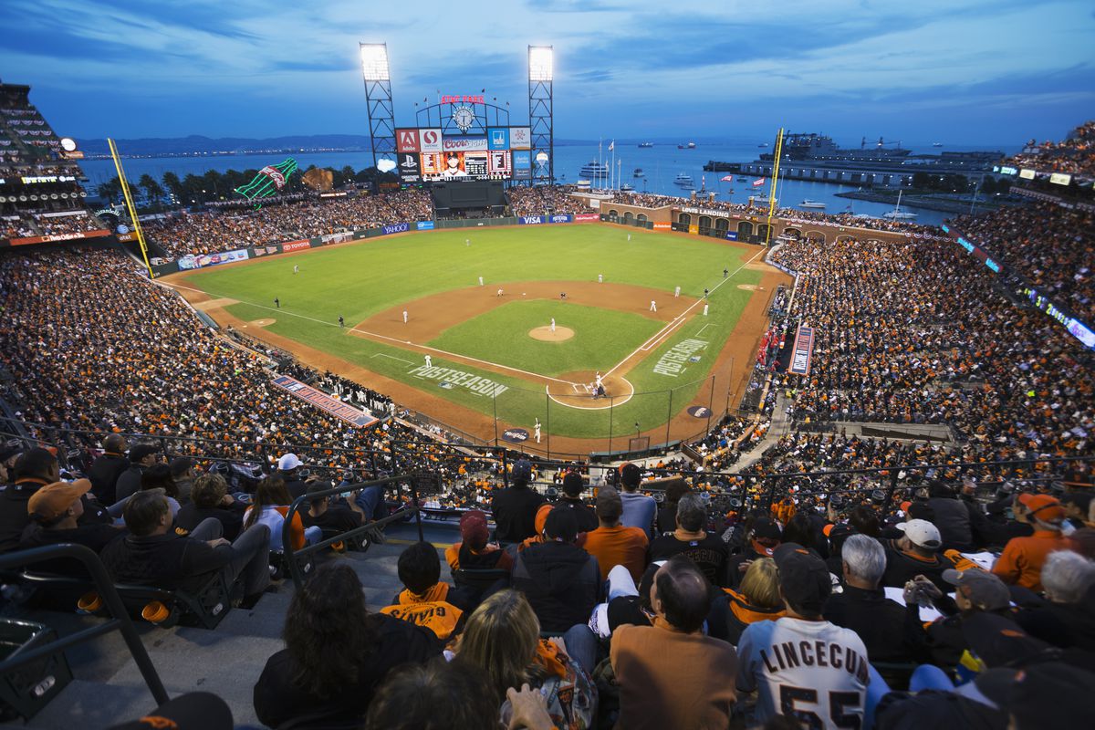 AT&amp;T Park at night, filled with fans.