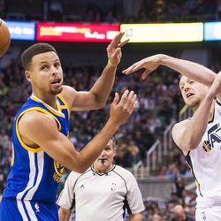 Utah forward Joe Ingles (2) passes the ball around Golden State guard Stephen Curry (30) during the second half of an NBA basketball game in Salt Lake City on Thursday, Dec. 8, 2016. Golden State defeated Utah with a final score of 106-99.