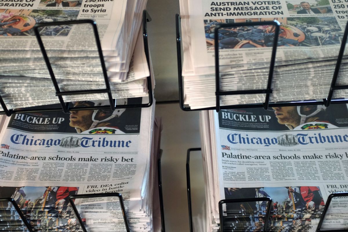 Chicago Tribune newspapers on a sales rack.