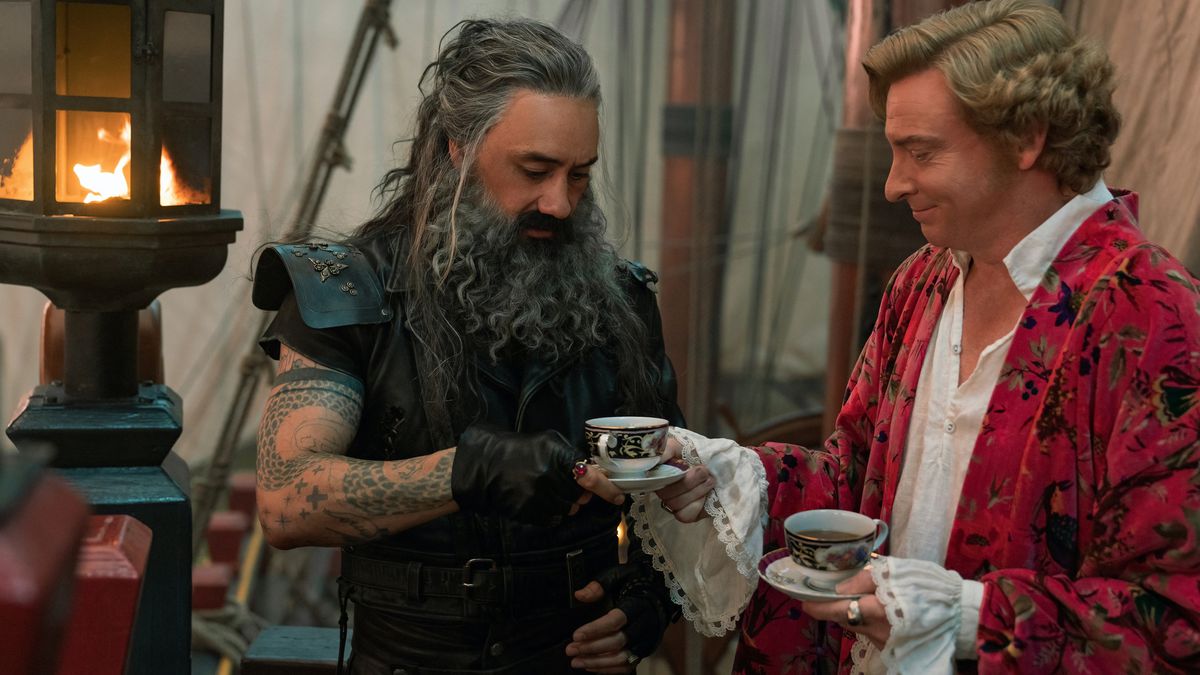 Blackbeard and Stede (Taika Waititi and Rhys Darby) share tea from pretty cups on deck in Our Flag Means Death
