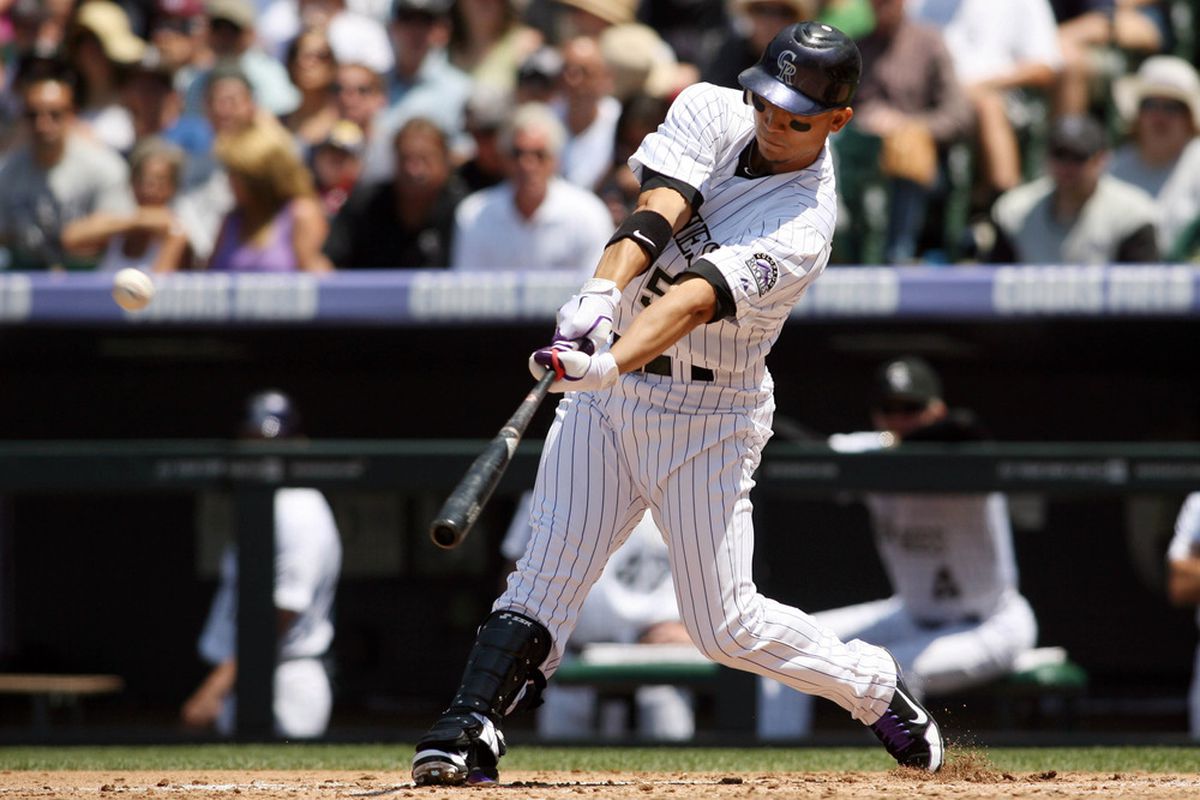 June 10, 2012; Denver, CO, USA; Colorado Rockies left fielder Carlos Gonzlaez hits a home run during  the second inning against the Los Angeles Angels at Coors Field.  Mandatory Credit: Chris Humphreys-US PRESSWIRE