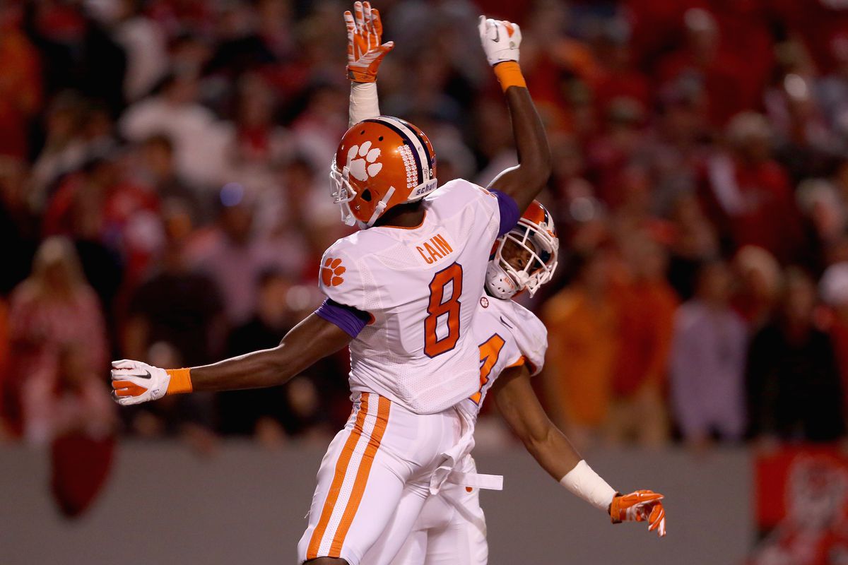 RALEIGH:  Clemson Tigers wide receiver Deon Cain (8) celebrates a touchdown scored by teammate Ray-Ray McCloud (34) against the North Carolina State Wolfpack defense at Carter-Finley Stadium.