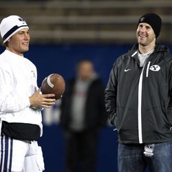 FILE -- Former BYU QB Max Hall, right, talks with Brigham Young Cougars quarterback Riley Nelson (13) prior to BYU's game with Idaho during NCAA football in Provo  Saturday, Nov. 12, 2011.