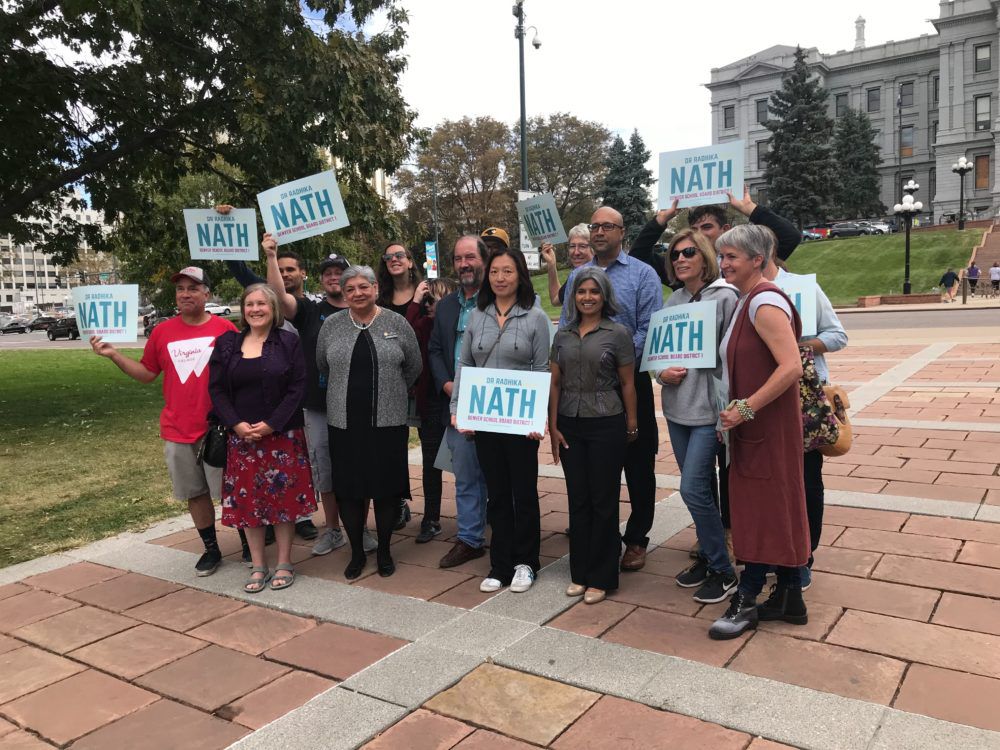Denver School Board candidate Radhika Nath, third from right, gathers with supporters in Civic Center Park.