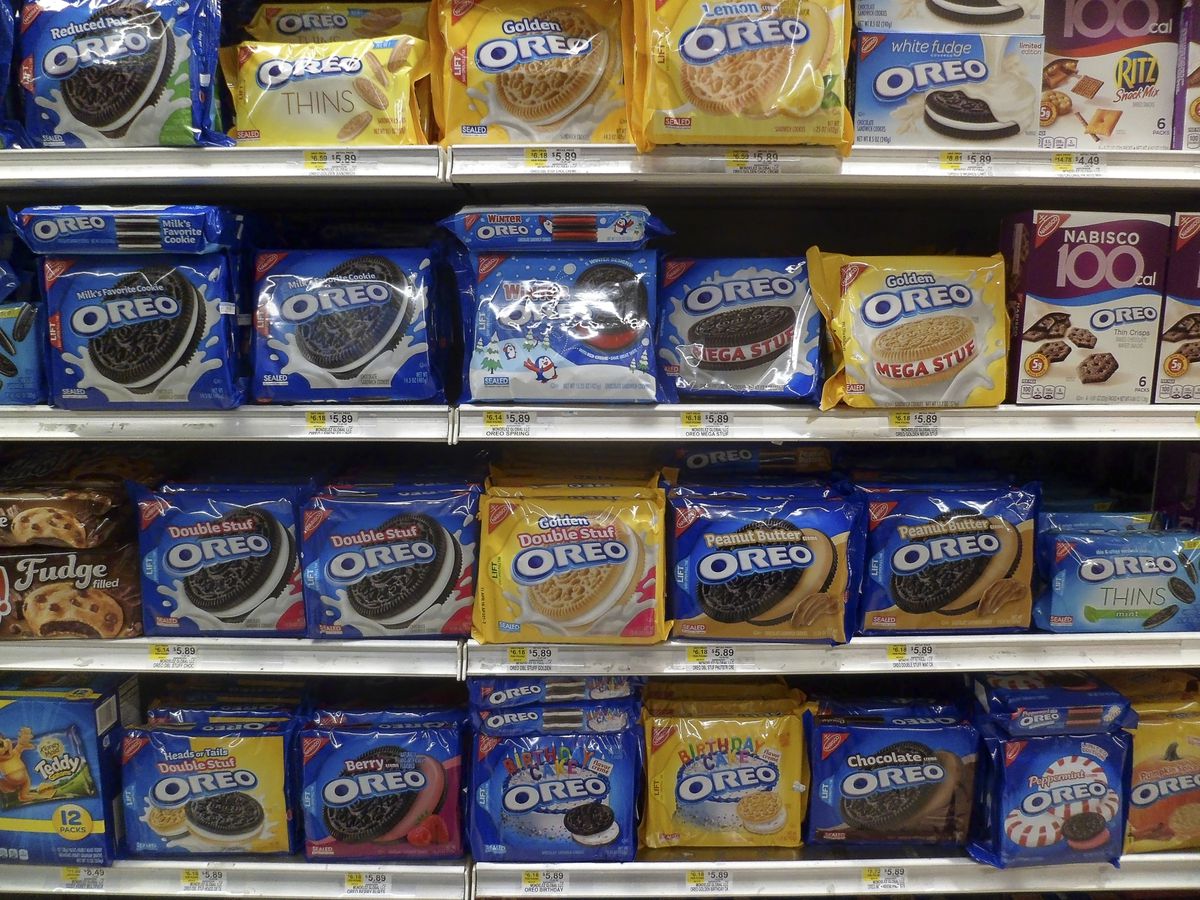 Grocery store shelves filled with packages of Oreo cookies.