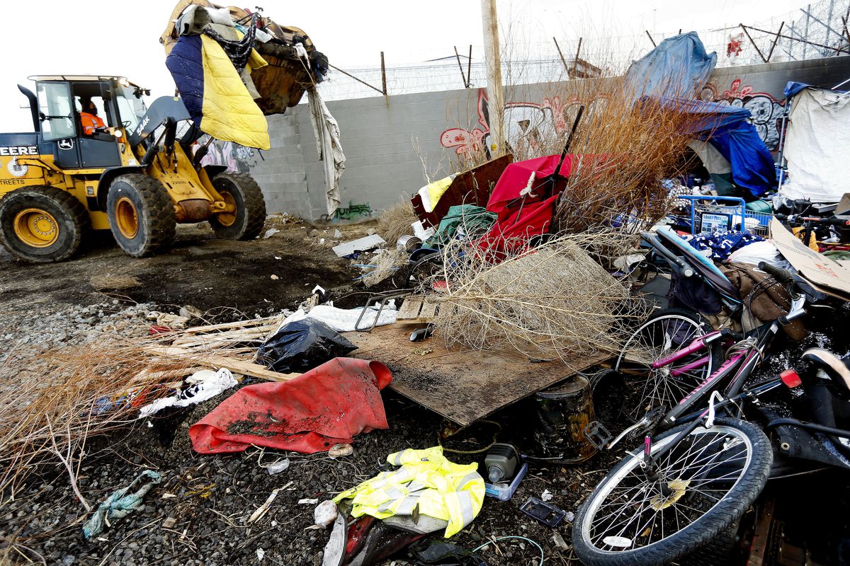 Crews with the Salt Lake County Health Department clear homeless encampments located adjacent to defunct Union Pacific railroad tracks in Salt Lake City on Thursday, Feb. 4, 2021. Approximately 180 people were camping in the area of 900 South and 500 West dubbed Camp Last Hope.