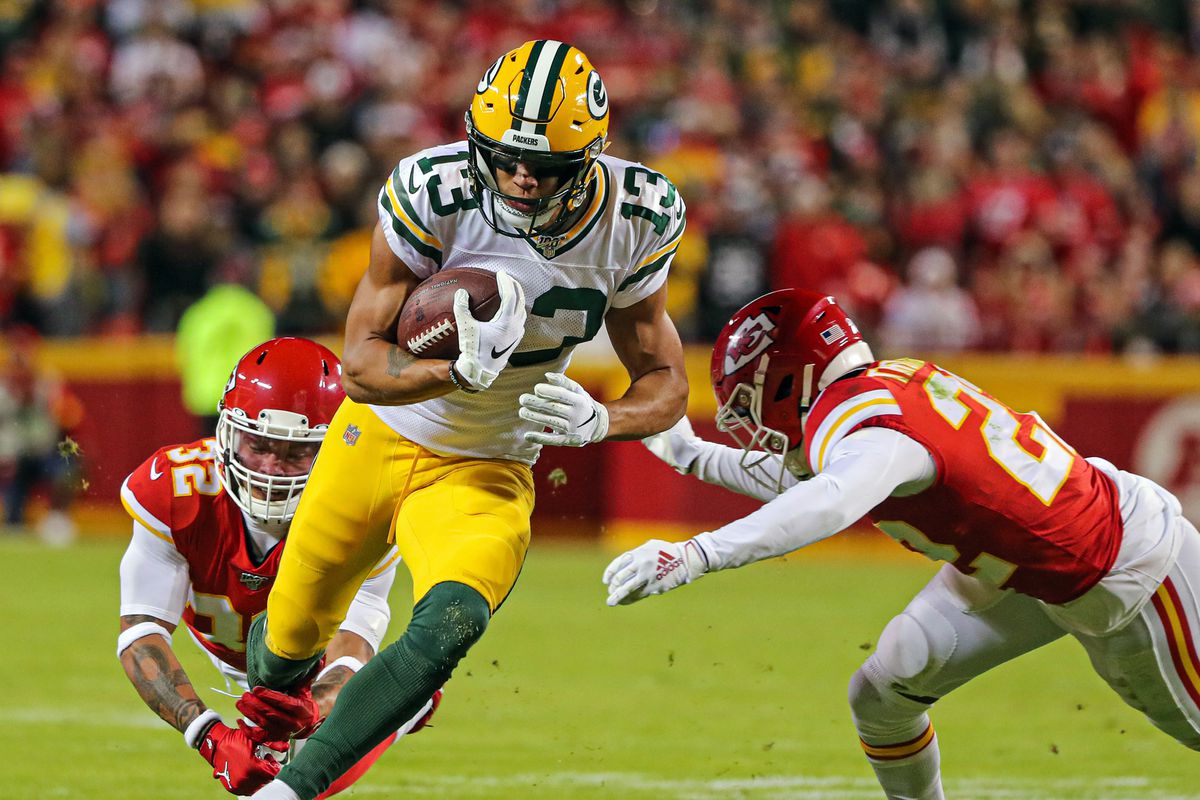 Green Bay Packers wide receiver Allen Lazard runs against Kansas City Chiefs strong safety Tyrann Mathieu and free safety Juan Thornhill during the second half at Arrowhead Stadium.