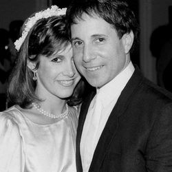 FILE - In this March 11, 1982 file photo, actress Carrie Fisher and singer-composer Paul Simon leave the Cathedral of St. John the Divine in New York, after a memorial service for comedian John Belushi. On Tuesday, Dec. 27, 2016, a publicist says Fisher has died at the age of 60. 