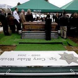 Loved ones pay their respects to the Wride family at the conclusion of the interment service for Utah County Sheriff's Sgt. Cory Wride at the Spanish Fork City Cemetery on Wednesday, Feb. 5, 2014.