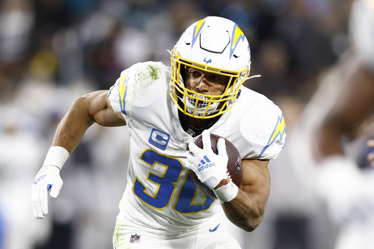Austin Ekeler #30 of the Los Angeles Chargers carries the ball against the Jacksonville Jaguars during the first half of the game in the AFC Wild Card playoff game at TIAA Bank Field on January 14, 2023 in Jacksonville, Florida.