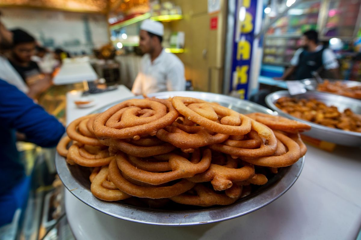 A plate of jalebi sits on a counter.