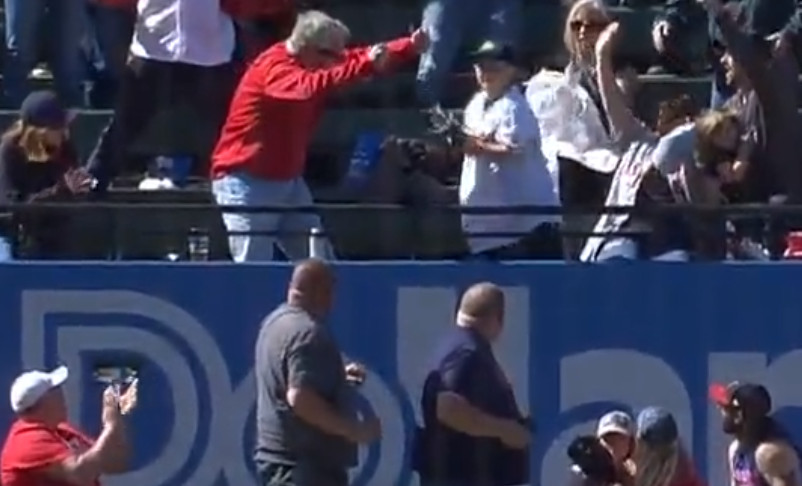 fans celebrate around child who made great catch on Owen Miller home run