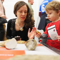 Meghan and her son Aidan look at artifacts as the Natural History Museum of Utah opens up the back rooms for visitors to see items that aren't out for regular viewing Saturday, Nov. 12, 2016.