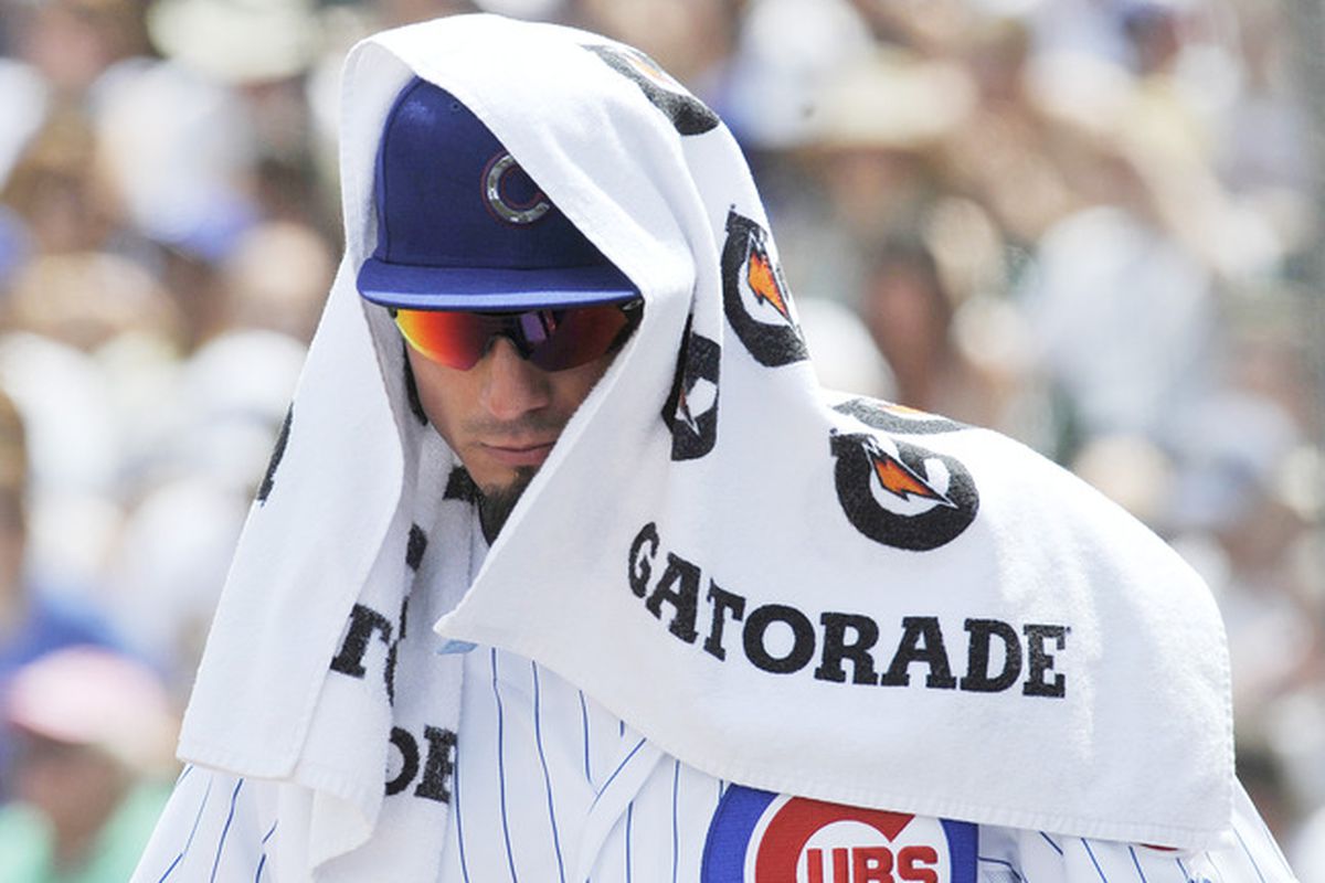 Matt Garza of the Chicago Cubs tries to stay cool on a 90 degree day during a game against the San Diego Padres at Wrigley Field in Chicago, Illinois.  (Photo by David Banks/Getty Images)