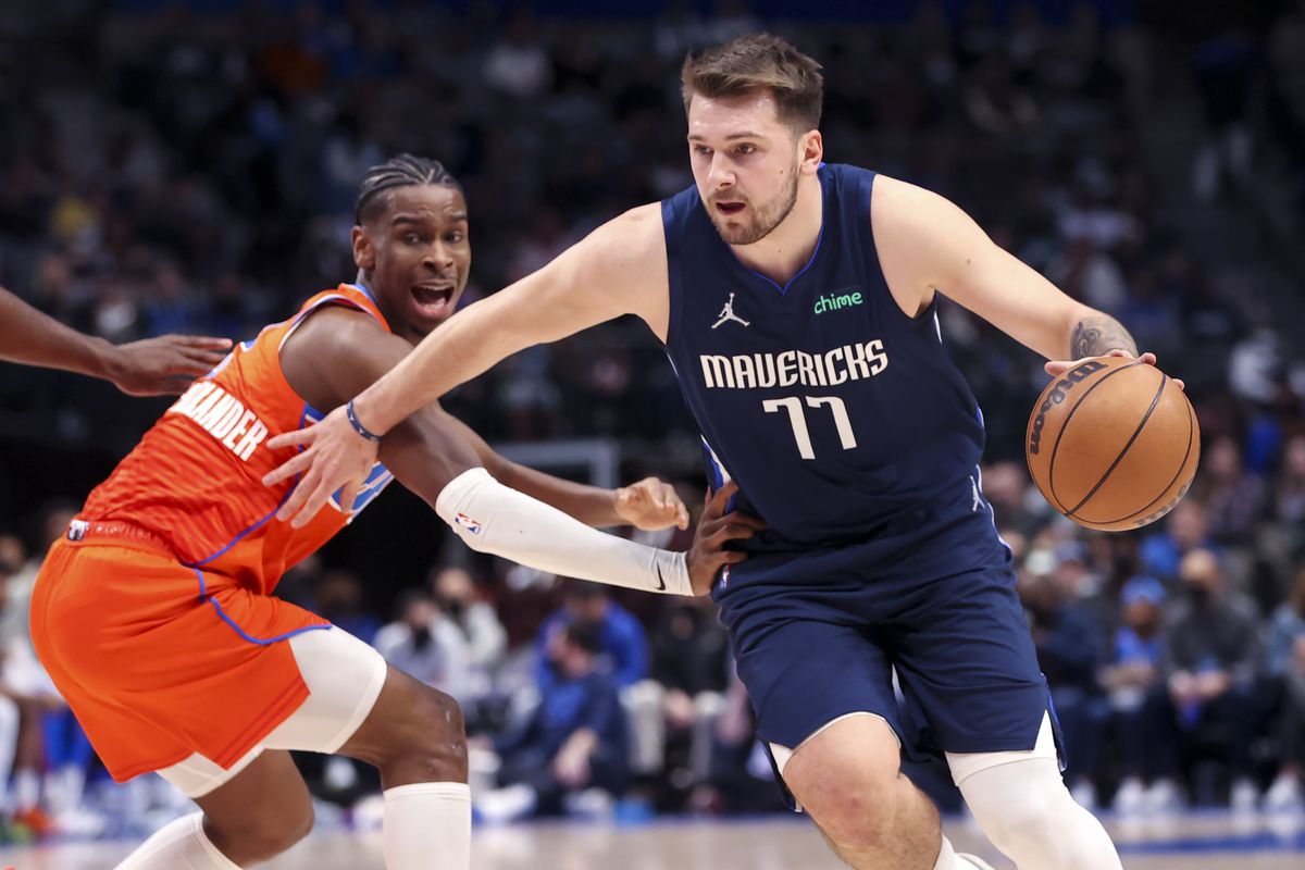 Dallas Mavericks guard Luka Doncic (77) drives to the basket past Oklahoma City Thunder guard Shai Gilgeous-Alexander (2) during the first quarter at American Airlines Center.