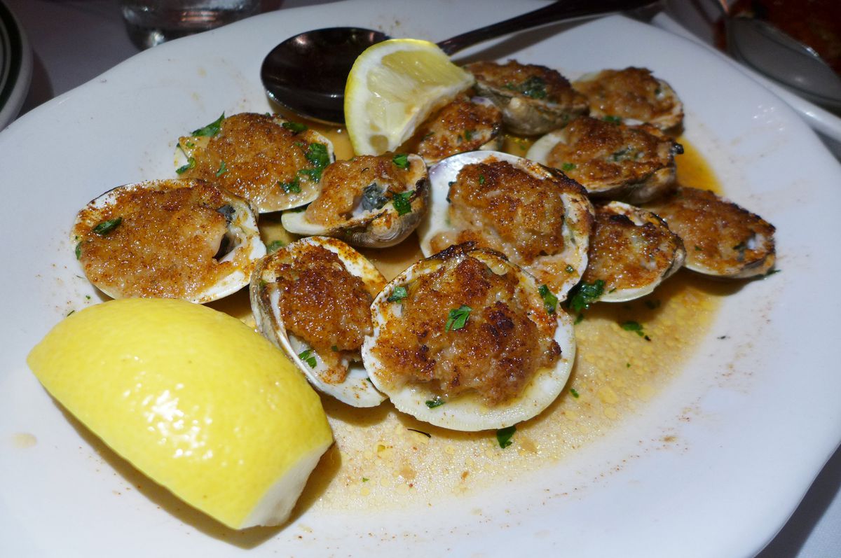 A dozen clams stuffed with bread crumbs and sided with lemon wedges...