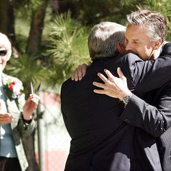 Pamela Atkinson applauds as Gov. Jon Huntsman Jr. hugs former Salt Lake Mayor Palmer DePaulis.