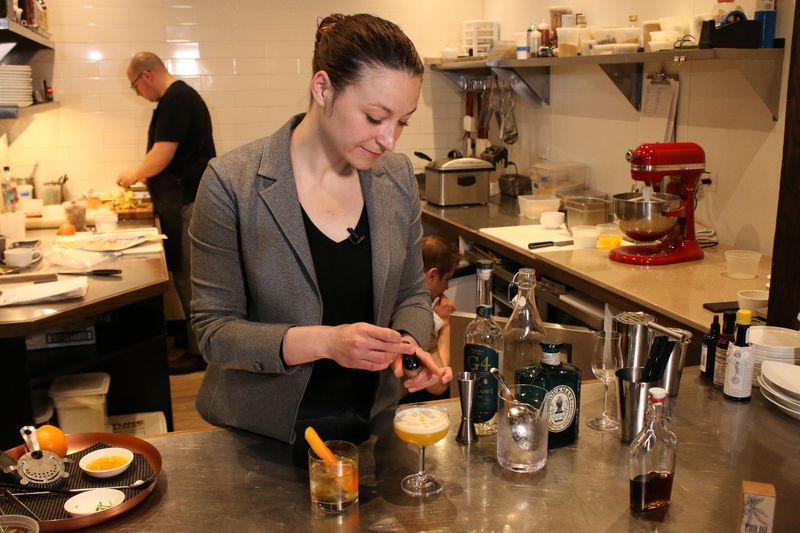 Sarah Traynor, the Beverage Director at Brass Heart restaurant in Uptown, tops a cocktail with drops of CBD oil. | Brian Rich/Sun-Times