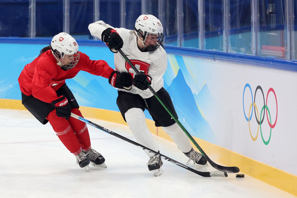 Alina Marti #28 and Lena Marie Lutz #71 of Team Switzerland fight for the puck during a Women’s Ice Hockey practice session ahead of the Beijing 2022 Winter Olympics Games at the National Indoor Stadium on February 02, 2022 in Beijing, China.