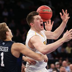 Valparaiso Crusaders forward Alec Peters (25) reacts as he is fouled by Brigham Young Cougars guard Nick Emery (4) as BYU and Valparaiso play in NIT Semifinal action at Madison Square Garden in New York City, on Tuesday, March 29, 2016.
