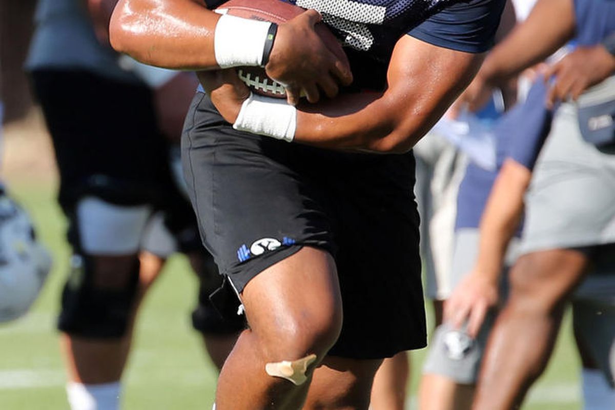 Ula Tolutau runs with the ball during football practice at BYU in Provo on Monday, July 31, 2017. 