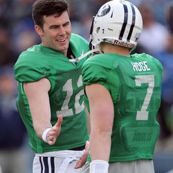 Brigham Young Cougars quarterback Tanner Mangum (12) congratulates fellow quarterback Beau Hoge (7) during a spring football scrimmage at LaVell Edwards Stadium in Provo, Saturday, March 26, 2016.