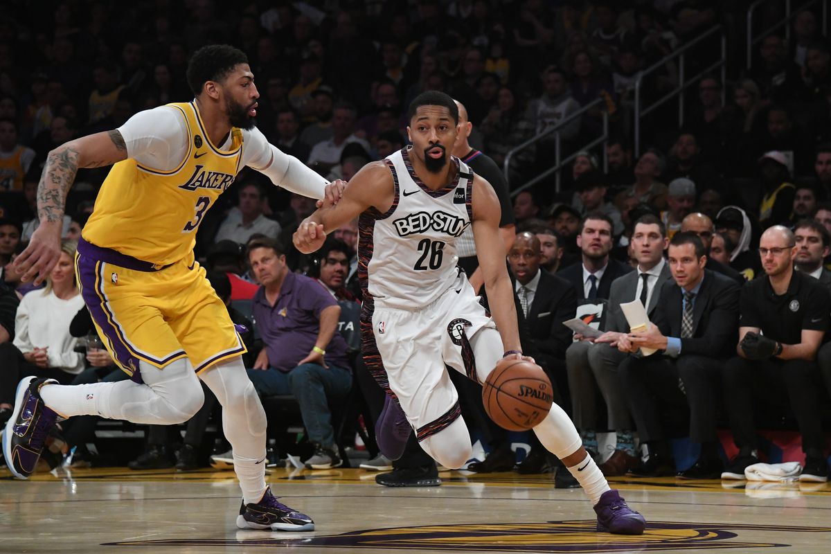 Brooklyn Nets guard Spencer Dinwiddie drives down the court defended by Los Angeles Lakers forward Anthony Davis in the first half at Staples Center.