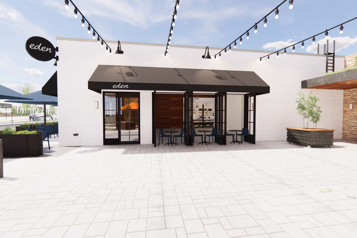 A computer rendering of the outside of a building with string lights hanging and a black awning above sliding doors.