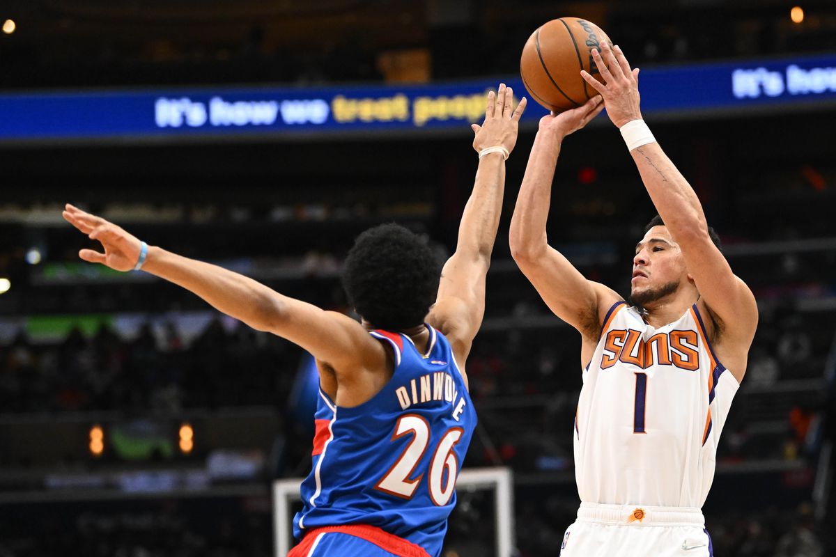Phoenix Suns guard Devin Booker (1) shoots over Washington Wizards guard Spencer Dinwiddie (26) during the first half at Capital One Arena.